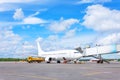 Passenger plane parked at the airport attached to the telescopic bridge of the naf one airport terminal building blue summer sky