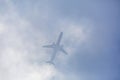 Passenger plane passing through the clouds Royalty Free Stock Photo