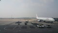 Passenger plane standing in airport on the concrete paved runway terminal Royalty Free Stock Photo