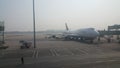 Passenger plane standing in airport on the concrete paved runway terminal Royalty Free Stock Photo