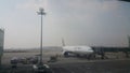 Passenger plane standing in airport on the concrete paved runway terminal Royalty Free Stock Photo