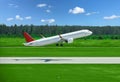 Passenger plane takes off from airport runway in forest Royalty Free Stock Photo