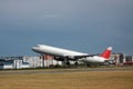 Passenger plane takes off from the airport runway. Side-view of aircraft Royalty Free Stock Photo