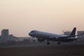 Passenger plane takes off from the airport runway. Side-view of aircraft Royalty Free Stock Photo