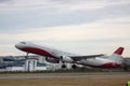 Passenger plane takes off from the airport runway. Side-view of aircraft Royalty Free Stock Photo