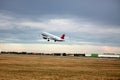 Passenger plane takes off from the airport runway. Side-view of aircraft Royalty Free Stock Photo