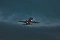 Passenger plane takes off at dusk, soon night Royalty Free Stock Photo