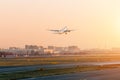 Passenger plane taking off in the sky sunset airport. Royalty Free Stock Photo