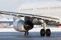 Passenger plane taxiing on the airport runway. Back view. Royalty Free Stock Photo