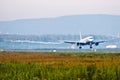 Passenger plane before touching runway landing with vortexes coming from wingtips.