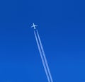 a passenger plane with vapour trails Royalty Free Stock Photo