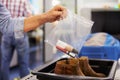 Passenger Puts Liquids Into Bag At Airport Security Check Royalty Free Stock Photo