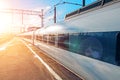 Passenger railway carriage train on railroad station at sunset Royalty Free Stock Photo