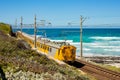 Passenger railway along a beach in the small coastal town of Fish Hoek in Cape Town, South Africa