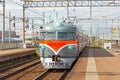 Passenger retro electric train at the station near the railway.