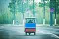 Passenger rickshaw on the empty road at foggy morning time.