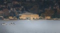 Passenger seaplane landing on Lake Como among small fisherman boats