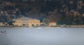 Passenger seaplane landing on Lake Como among small fisherman boats