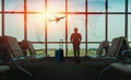 Passenger seat in departure lounge for see airplane, View from airport terminal. Sun light in vintage color selective focus, Trans Royalty Free Stock Photo