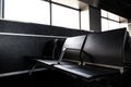 Passenger seat in Departure lounge where passengers can wait boarding to aircraft, view from airport terminal. Transport Royalty Free Stock Photo