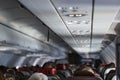 Passenger seat, Interior of airplane with passengers sitting on seats.