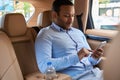 Passenger seated in auto using his cellphone