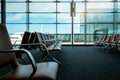 Passenger seats in departure lounge at airport terminal. Interior of airport terminal. Chairs in departure area at international Royalty Free Stock Photo