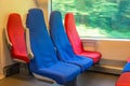 Passenger seats in red and blue colors inside the high-speed train Royalty Free Stock Photo