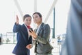 Passenger service agent assisting and giving directions with businesswoman in airport