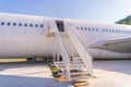 Passenger stair with boarding ramp steps. Commercial airplane, aircraft with blue sky background in travel trip and transportation Royalty Free Stock Photo