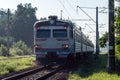 Passenger Suburban electric train rides on rails.