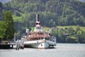 The passenger tourist steam boat leaving pier in central Switzerland