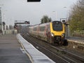 Passenger train approaching a railway station UK