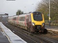 Passenger train approaching a station UK