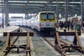 Passenger train arrived at the station in Ostend. Rails, trains, tourists on a hot sunny day.