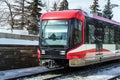 Passenger Train Arriving into a Station on a Sunny Winter Day Royalty Free Stock Photo