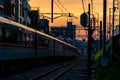 A Passenger Train Departing into a Sunset in Tokyo.