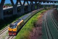 Passenger train by diesel locomotive passed the railway curve.