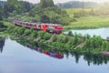 Passenger train moves along the lake