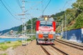 Passenger train moves along the mountains and Black sea