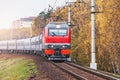 Passenger train moves by the autumn forest Royalty Free Stock Photo