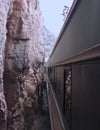 A Passenger Train Passes Inches from Towering Red Rock Walls Royalty Free Stock Photo