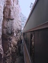 A Passenger Train Passes Inches from Towering Red Rock Walls