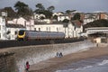 Passenger train passing Dawlish a seaside town in Devon England UK