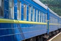 Passenger train is preparing to depart from the railway station, located in the mountains Royalty Free Stock Photo