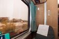 Passenger train seat and blurred window view Royalty Free Stock Photo