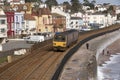 Passenger train on the seawall at Dawlish in Devon UK Royalty Free Stock Photo