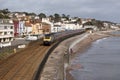 Passenger train on the seawall at Dawlish in Devon UK