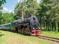 Passenger train with steam locomotive in motion