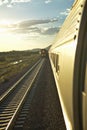 Passenger train traveling into the Arizona sunset Royalty Free Stock Photo